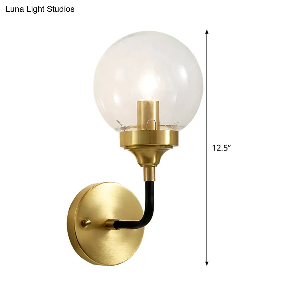 Clear Glass Globe Wall Sconce Light Fixture - Simple Brass With Curved Arm