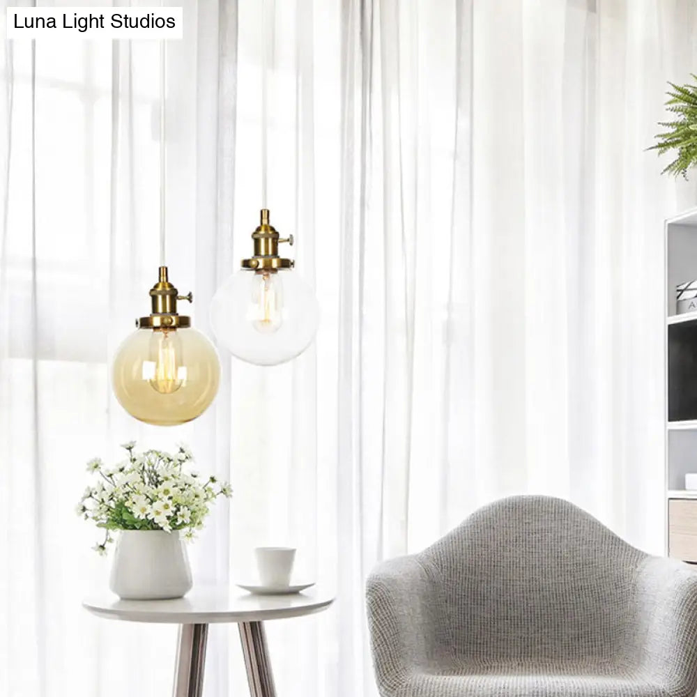 Farmhouse Orbit Pendant Light With Amber/Clear Glass And Adjustable Cord In 3 Elegant Finish Options