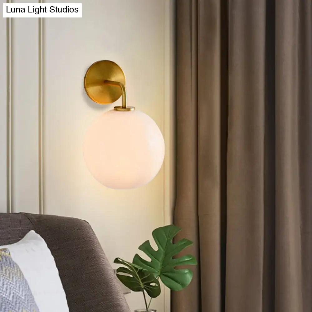Modern Glass Orb Wall Sconce With Brass Arm Clear/White