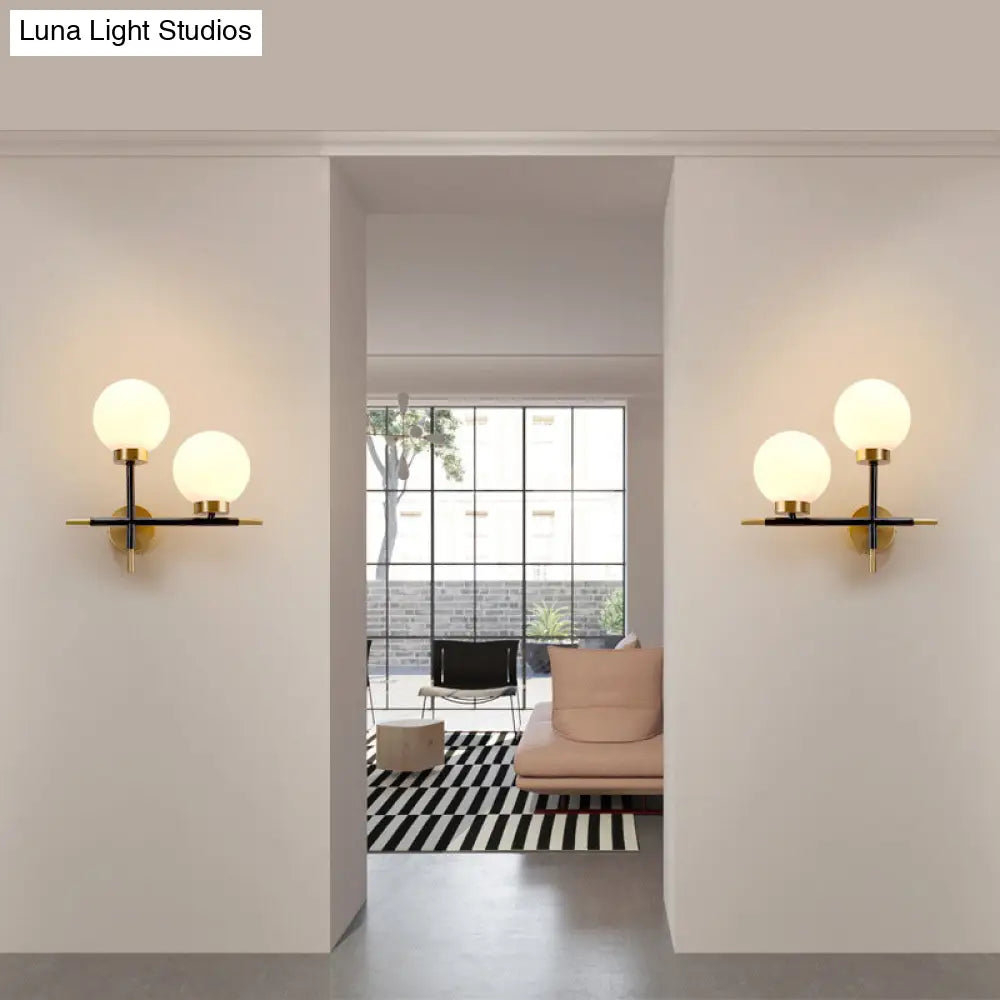 Post-Modern White Glass Sphere Wall Sconce With Brass Finish - 1/2 Bulbs