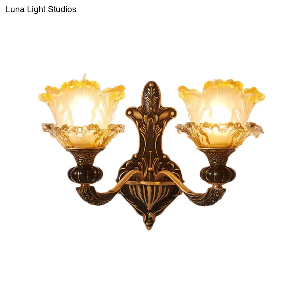 Rustic Half-Head Wall Lamp With Curvy Metallic Design And Flower Amber Glass Shade - Brass Finish