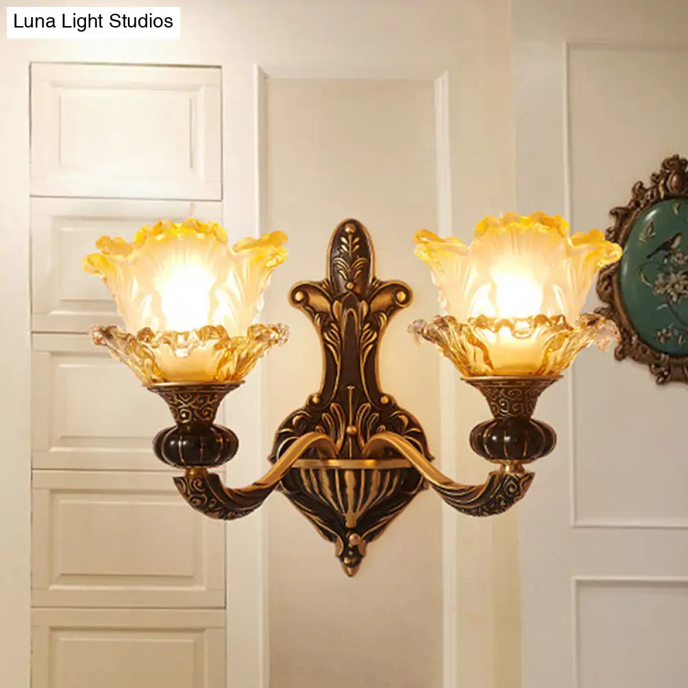 Rustic Half-Head Wall Lamp With Curvy Metallic Design And Flower Amber Glass Shade - Brass Finish