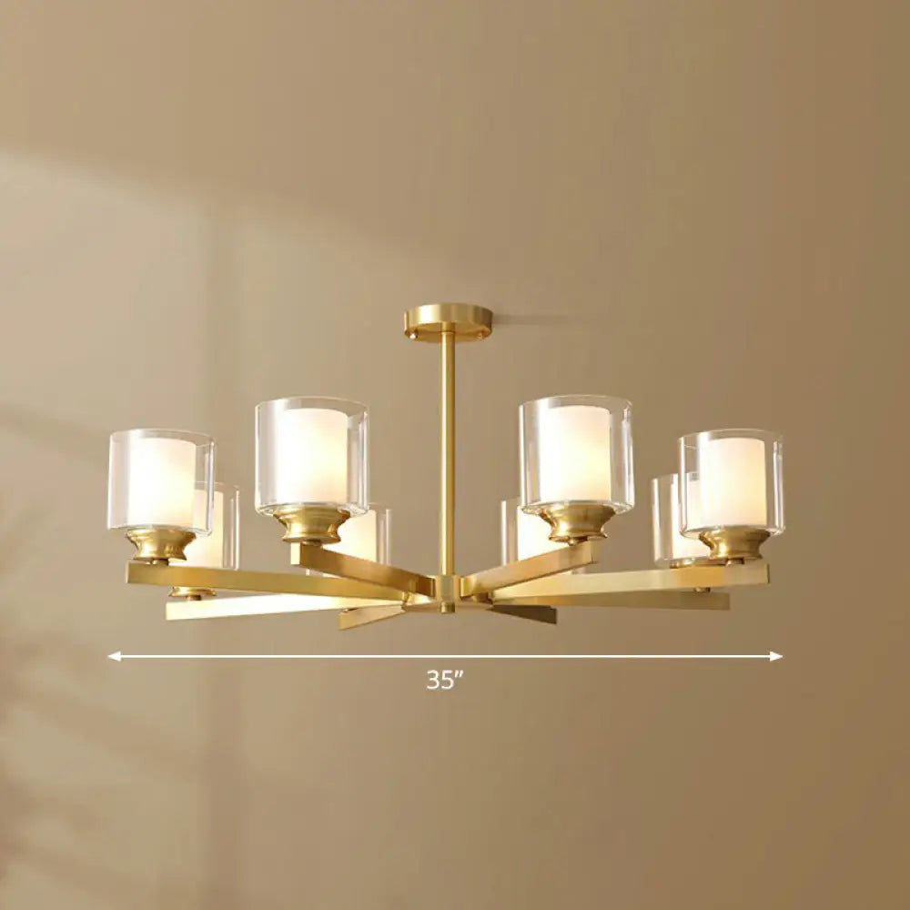 Sleek Brass Cylindrical Hanging Lamp With Clear And Frosted Glass Minimalistic Dining Room