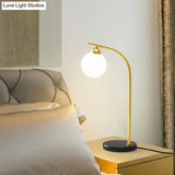 Albaldah - Ivory Glass Ball Shade Table Light With Black/Gold Bended Stand