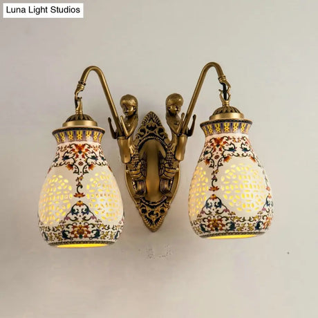 Antique Brass Ceramic Wall Sconce With Pierced Jar Traditional Patterned Design And Small Mermaid