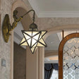 Antique Brass Tiffany Wall Sconce With White Glass Star Illumination And Mermaid Backplate