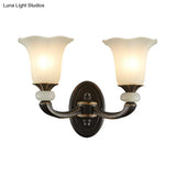 Antiqued Flower Wall Light Fixture - Black And Gold Frosted Glass Mounted Lamp