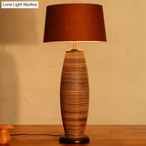 Asia Wood Small Desk Lamp With Oval Task Lighting Coffee Color And Fabric Drum Shade