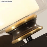 Black 1-Light Wall Sconce - Traditional Metal Cylinder With Double-Tier Glass Shade For Bedroom