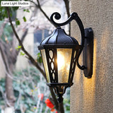 Black Outdoor Wall Mount Lantern Sconce With Clear Water Glass Shade - 1-Head Country Style Lamp