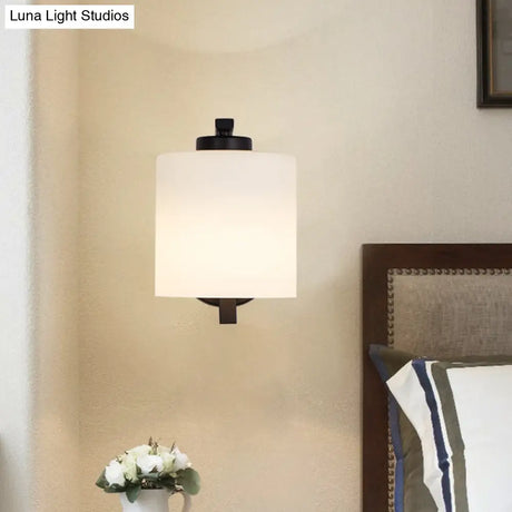 Black Wall Sconce With Ivory Glass Cylinder And Curved Arm - 1-Light Mounted Lamp