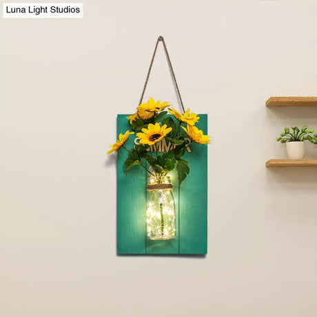 Clear Bottle Wall Sconce With Led And Rustic Teal Plant Decoration