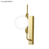 Globe Living Room Sconce - Frosted White Glass Modern Wall Light With Gold Backplate