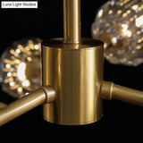 Gold Finish Chandelier With Metallic Branch Design And Clear Crystal Shade