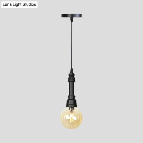 Industrial Black Finish Amber Glass Pendant Lamp With Pipe Suspension - 1-Light Ball/Capsule