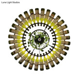 Industrial Led Wine Bottle Wall Sconce With Metal Fixture And Plant Accent In Black