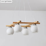 Japanese Style 4-Bulb Cream Glass Sphere Pendant Chandelier For Living Room In Wood