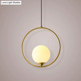 Minimalist Antique Gold Ball Ceiling Lamp With Cream Glass Shade And Ring Decoration