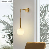 Minimalist Mini Globe Wall Sconce With Cream Glass And Gold Finish For 1-Bulb Lighting