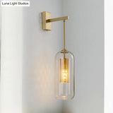 Modern 1-Head Gold Wall Mount Light For Bedside - Clear Glass Capsule Sconce Fixture