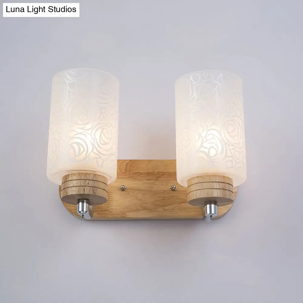 Modern 2-Headed White Glass Cylinder Wall Sconce With Wood Mount And Rose Pattern