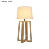 Modern Beige Trapezoid Nightstand Lamp With Wood Base And Tapered Fabric Shade