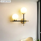 Modern Black Double Globe Wall Lamp With Cross Design - 2-Bulb Milky Glass Sconce Light Fixture For