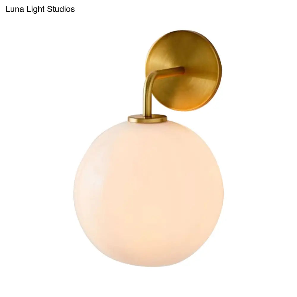 Modern Glass Orb Wall Sconce With Brass Arm Clear/White