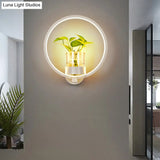 Modern Metal Wall Sconce With Artistic Loop Design And Clear Glass Plant Pot