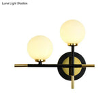 Modern Milk Glass Orb Sconce Wall Light - 2 Lights Black And Brass Cross Design