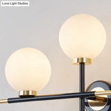 Modern Milk Glass Orb Sconce Wall Light - 2 Lights Black And Brass Cross Design
