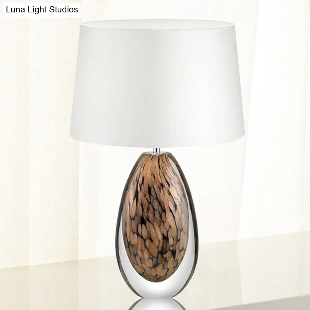 Modernist White Fabric Desk Lamp With Teardrop Brown Glazed Crystal Base - 1 Head Tapered Table