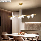 Nordic Metal 6-Head Linear Island Light With Gold Finish And Clear Glass Globes