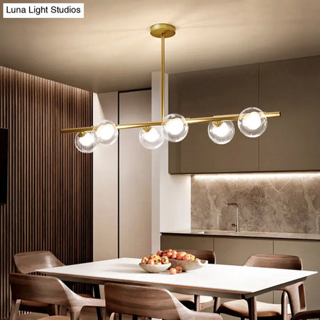 Nordic Metal 6-Head Linear Island Light With Gold Finish And Clear Glass Globes