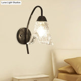 Post-Modern Black Metal Wall Mount Light With Clear Crystal Shade - Trapezoid/Flower/Drum Design