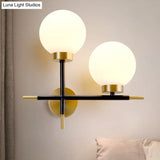 Post-Modern White Glass Sphere Wall Sconce With Brass Finish - 1/2 Bulbs