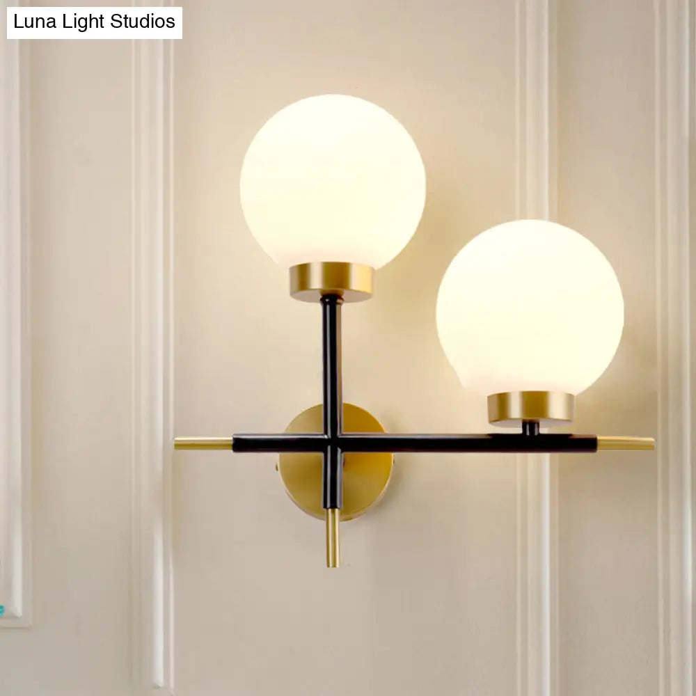 Post-Modern White Glass Sphere Wall Sconce With Brass Finish - 1/2 Bulbs