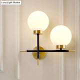 Post-Modern White Glass Sphere Wall Sconce With Brass Finish - 1/2 Bulbs