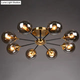 Postmodern Brass Flush Mount Light With Burst Design And Glass Ball For Living Room