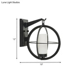 Rustic Black Cylinder Sconce With Frosted Glass And Metal Cage