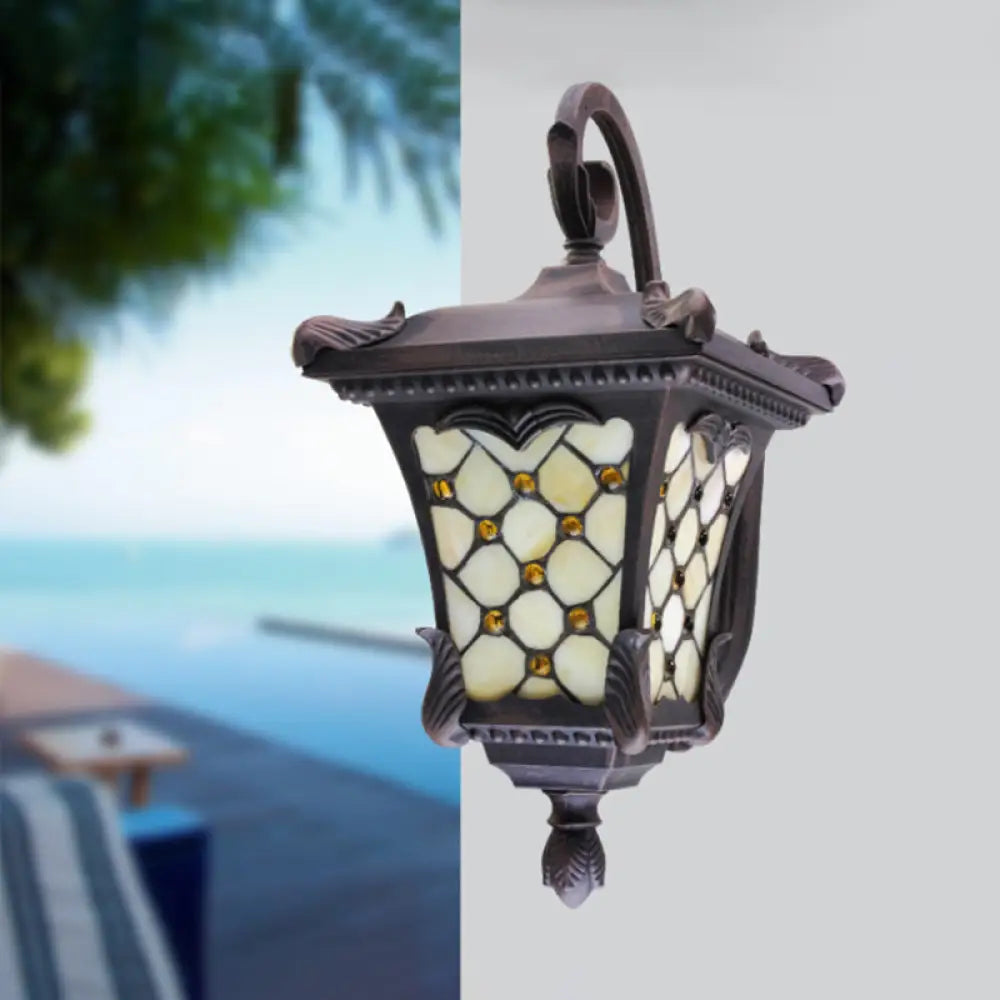 Rustic Black Wall Sconce With Scrolled Arm And Frosted Glass For Outdoor Use
