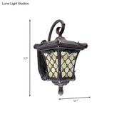 Rustic Black Wall Sconce With Scrolled Arm And Frosted Glass For Outdoor Use