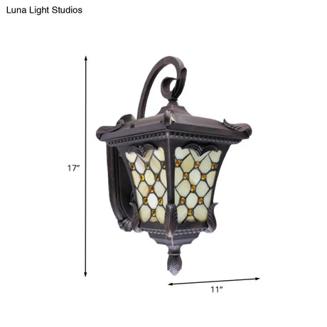 Rustic Black Wall Sconce With Scrolled Arm And Frosted Glass For Outdoor Use