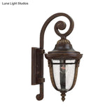 Rustic Bronze Scrolling Arm Metal Wall Lamp - 1 Light Outdoor Sconce With Seedy Glass Shade
