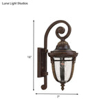Rustic Bronze Scrolling Arm Metal Wall Lamp - 1 Light Outdoor Sconce With Seedy Glass Shade