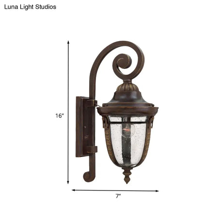 Rustic Bronze Scrolling Arm Metal Wall Lamp - 1 Light Outdoor Sconce With Seedy Glass Shade