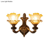 Rustic Half-Head Wall Lamp With Curvy Metallic Design And Flower Amber Glass Shade - Brass Finish