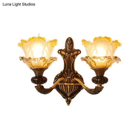 Rustic Half-Head Wall Lamp With Curvy Metallic Design And Flower Amber Glass Shade - Brass Finish