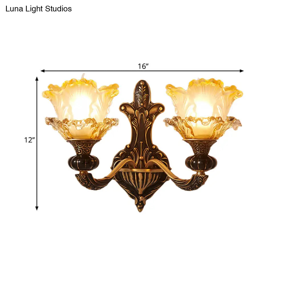 Rustic Half-Head Wall Lamp With Curvy Metallic Design And Flower Amber Glass Shade - Brass Finish
