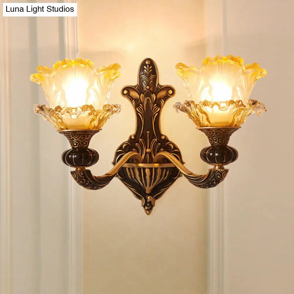 Rustic Half-Head Wall Lamp With Curvy Metallic Design And Flower Amber Glass Shade - Brass Finish